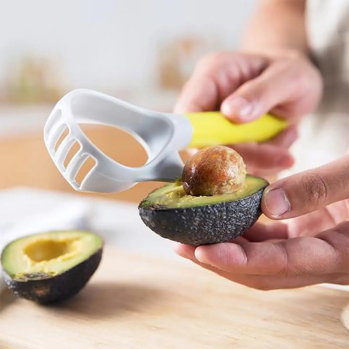 5-in-1 Avocado Slicer & Pitter Kit removing an avocado pit