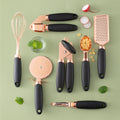 Rose gold 7-piece kitchen gadget set with grater, peeler, and whisk