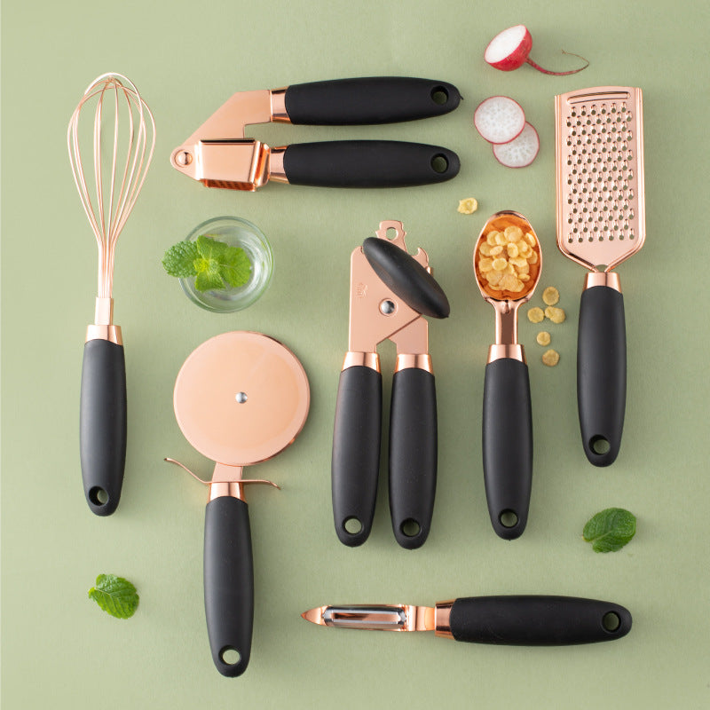 Rose gold 7-piece kitchen gadget set with grater, peeler, and whisk